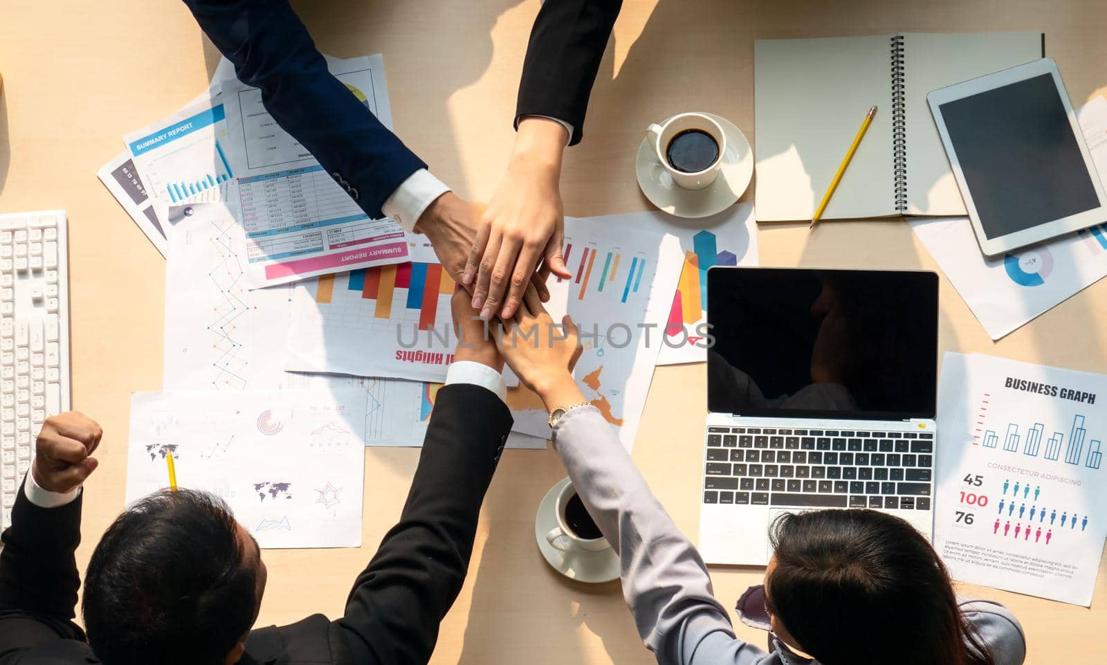 Top view on a group of businessman and businesswoman having a meeting and making a business commitment.