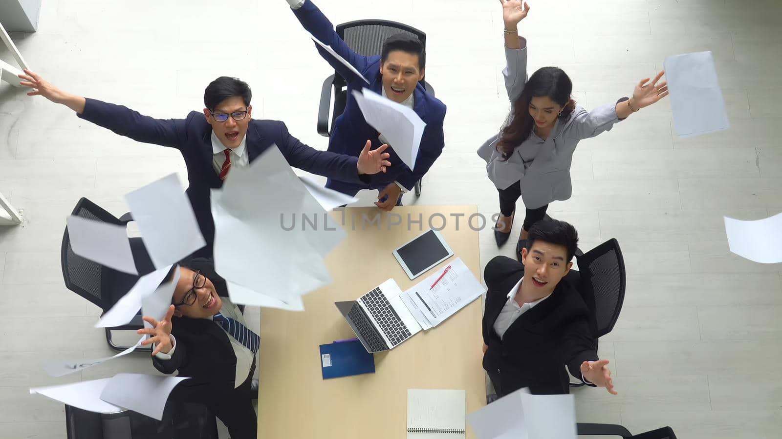 Top view on a group of businessman and businesswoman having a meeting and making a business commitment.