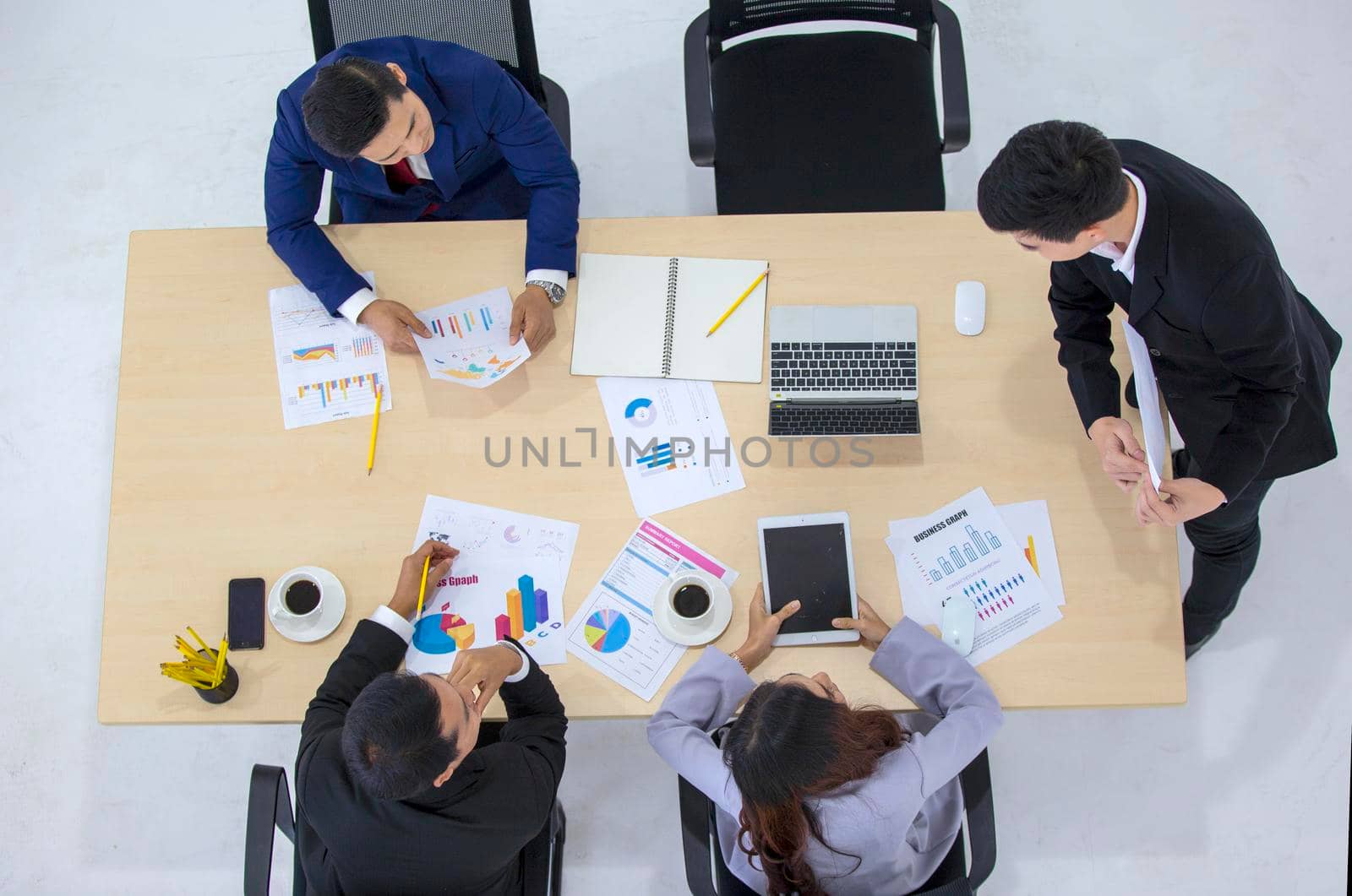 Top view on a group of businessman and businesswoman having a meeting and making a business commitment. by chuanchai