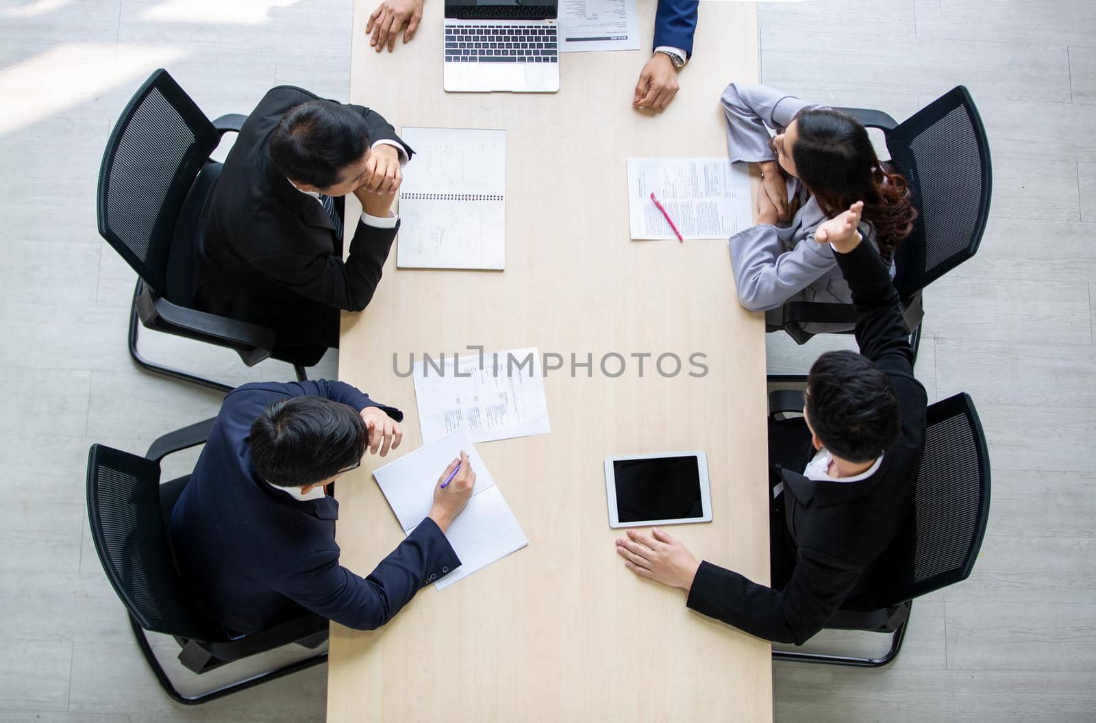 Top view on a group of businessman and businesswoman having a meeting and making a business commitment.