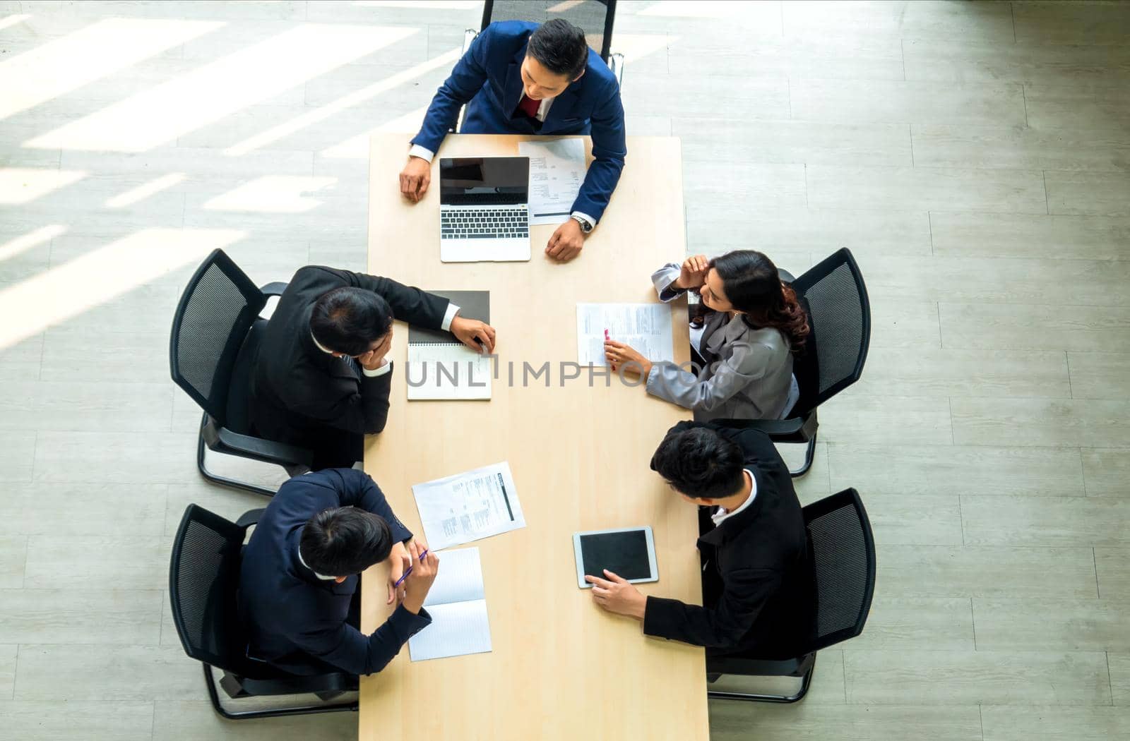 Top view on a group of businessman and businesswoman having a meeting and making a business commitment. by chuanchai