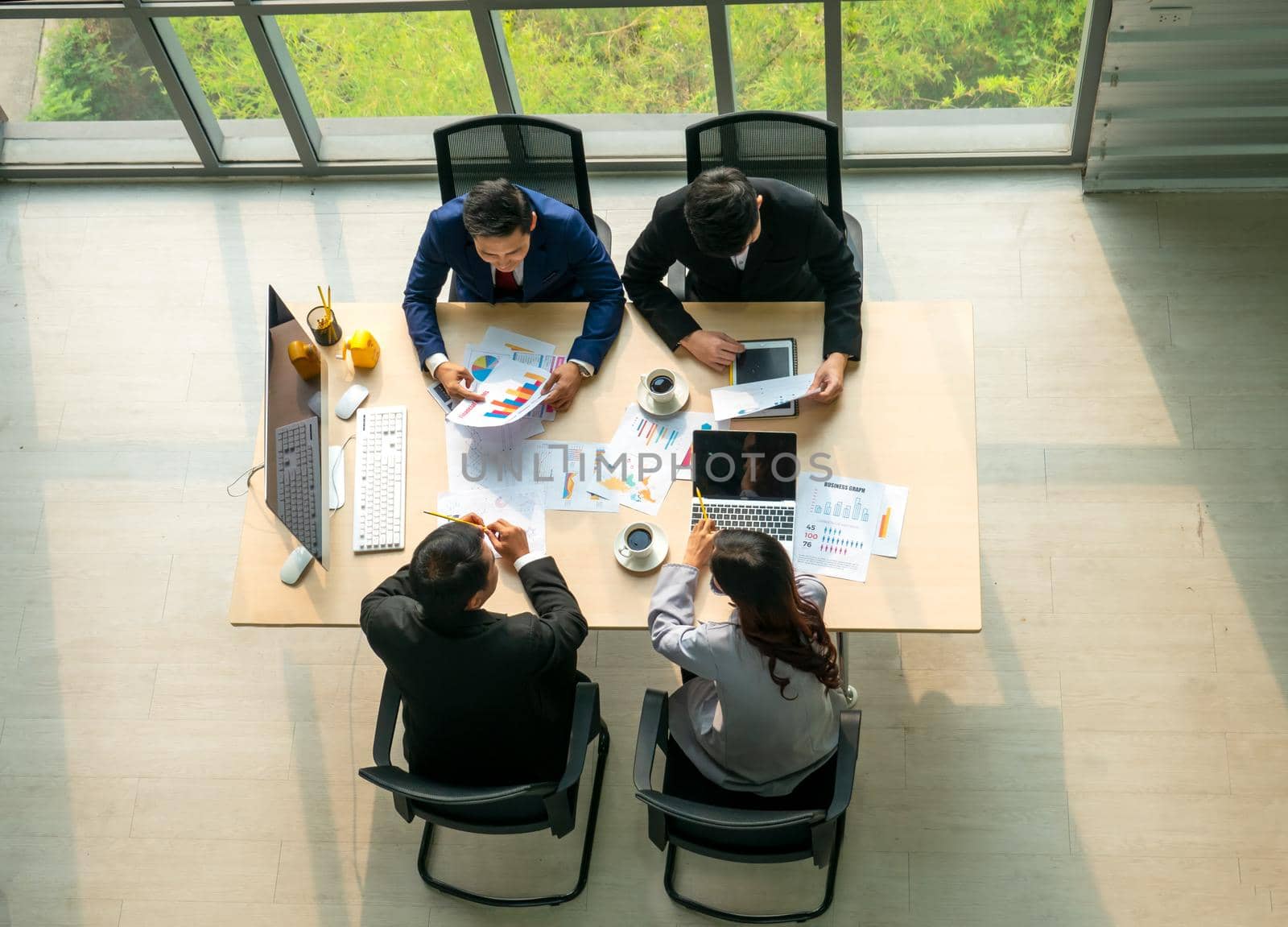 Top view on a group of businessman and businesswoman having a meeting and making a business commitment. by chuanchai