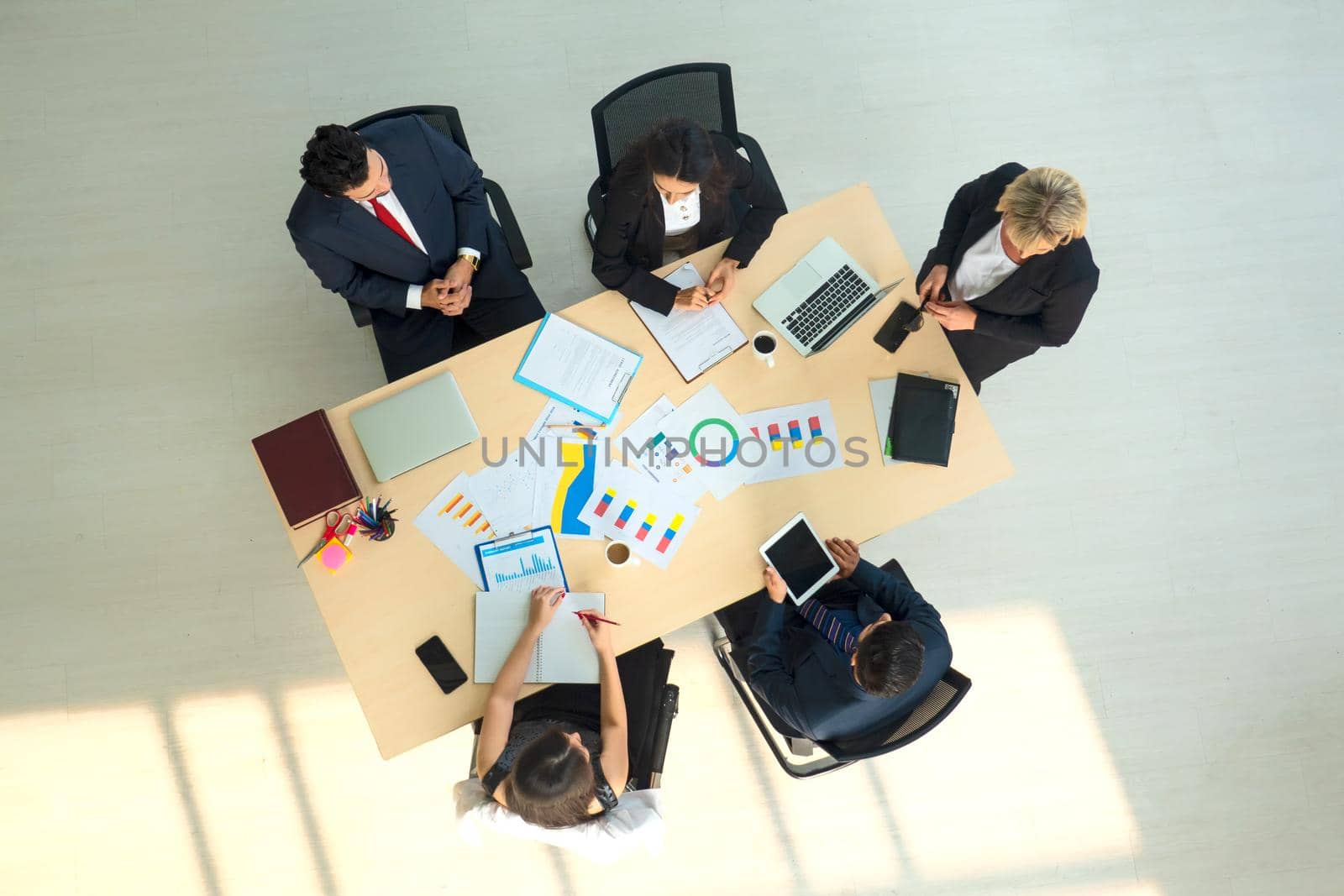 Top view on a group of businessman and businesswoman having a meeting and making a business commitment.