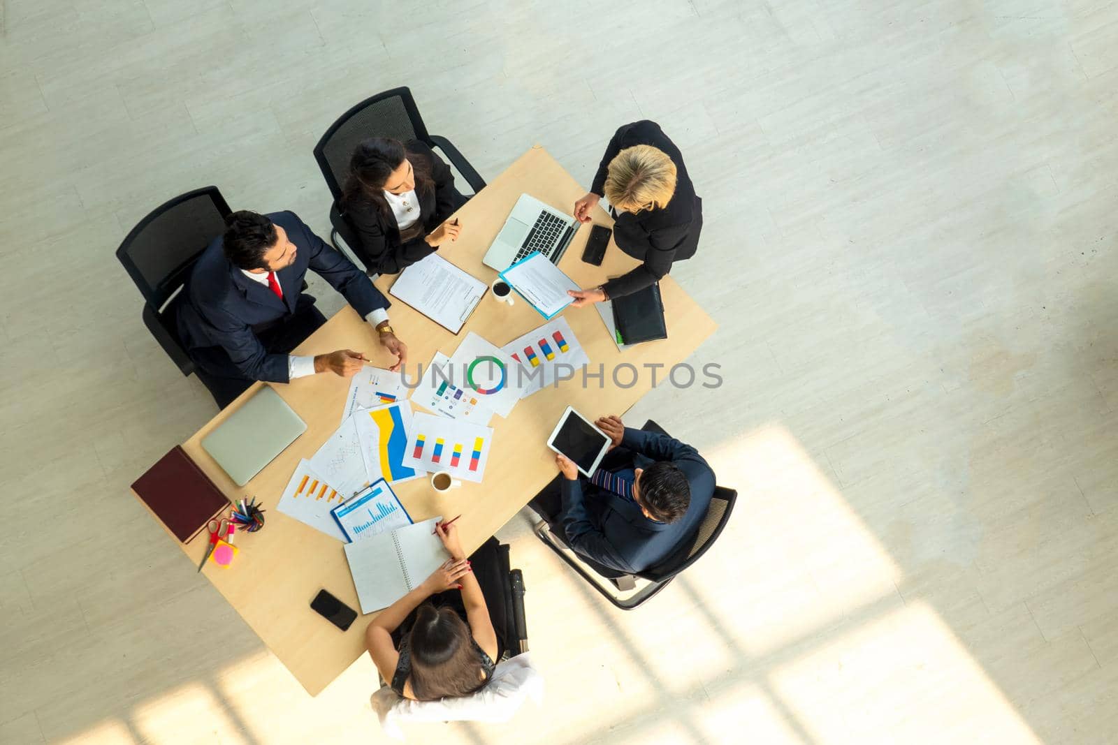 Top view on a group of businessman and businesswoman having a meeting and making a business commitment.