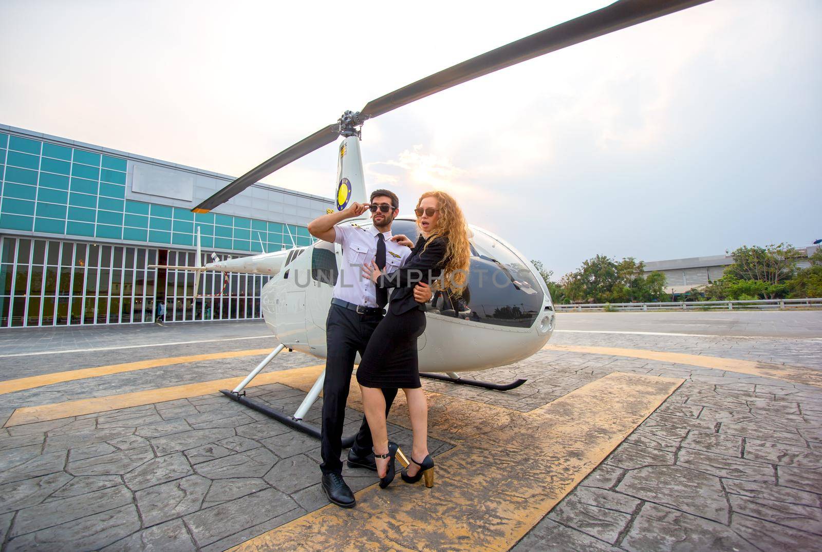 Business people traveling by helicopter , Shot of a mature businessman using a headset while traveling in a helicopter by chuanchai