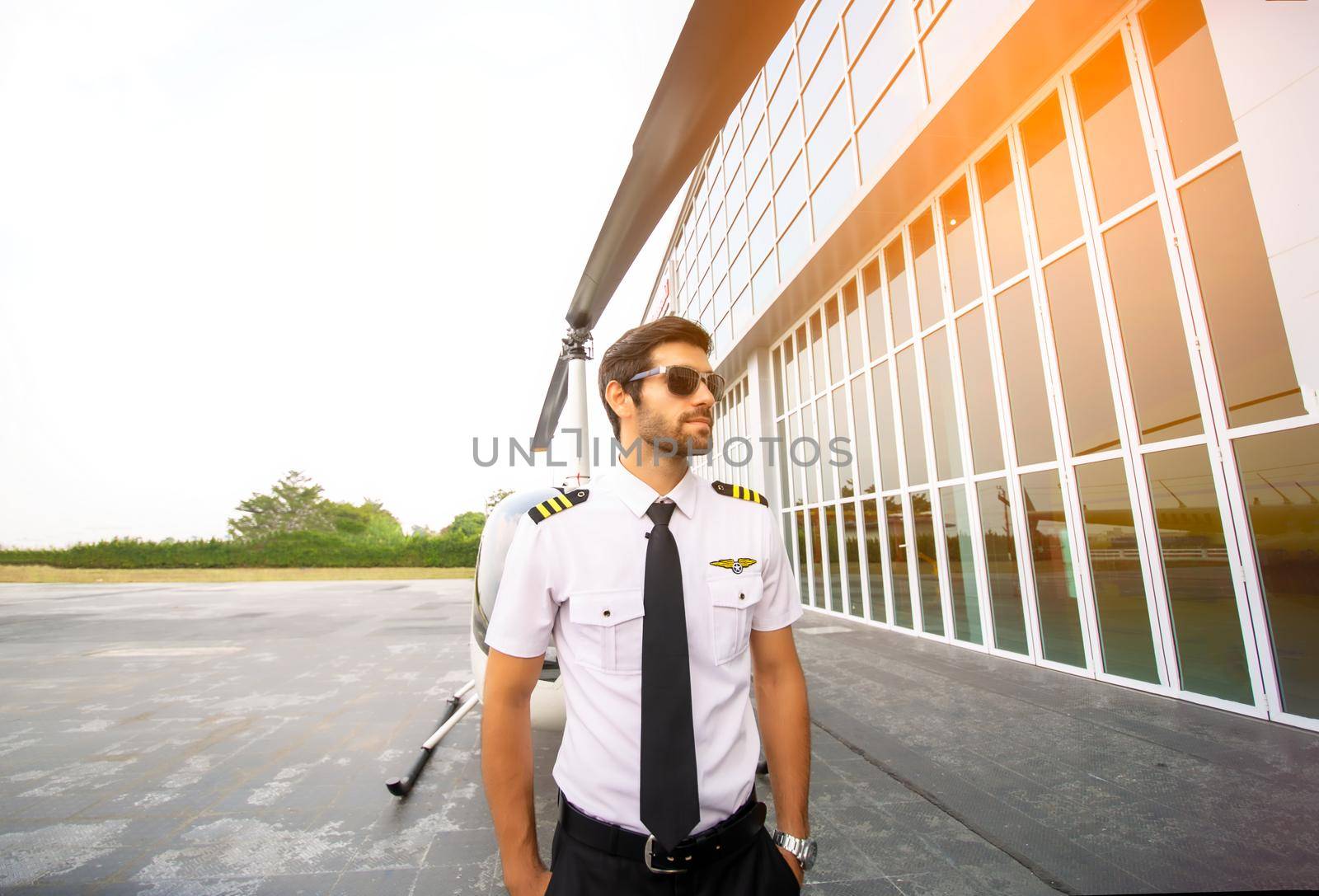 Shot of a mature Helicopter pilot using a headset while traveling in a helicopter, Business people traveling by helicopter