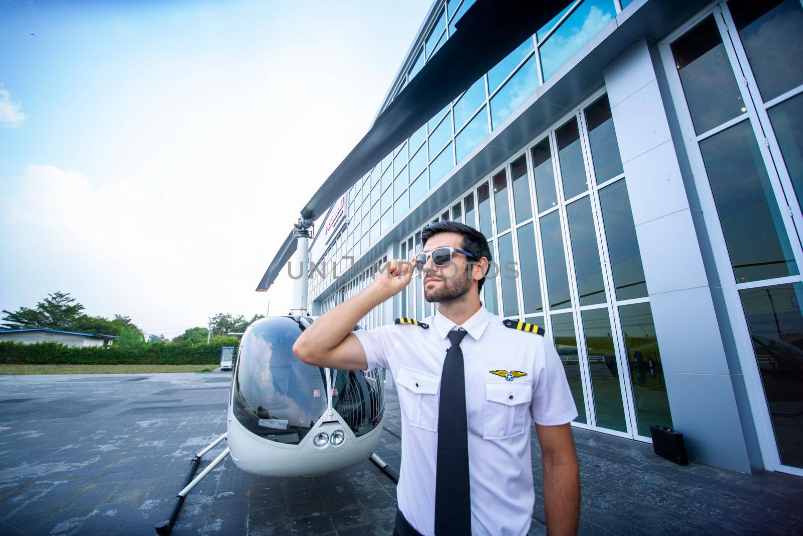 Shot of a mature Helicopter pilot using a headset while traveling in a helicopter, Business people traveling by helicopter