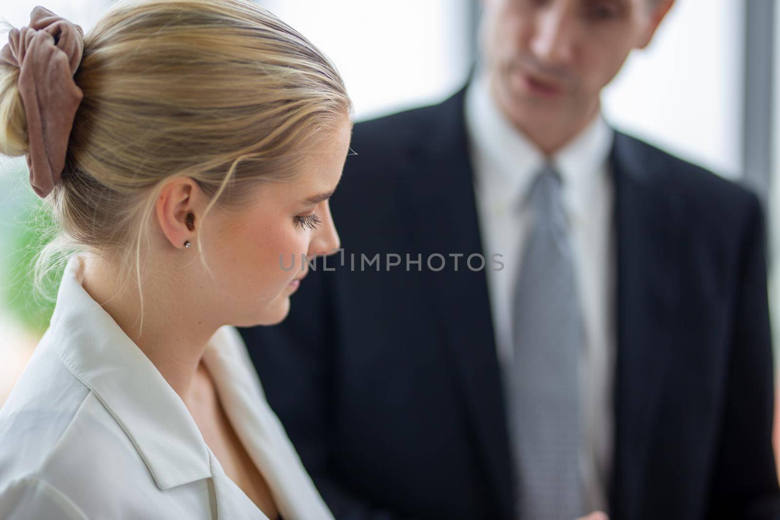 young business team working together at office. Manager pointing at a chart and explaining the analysis about business strategies. Top view shot of business hand shake