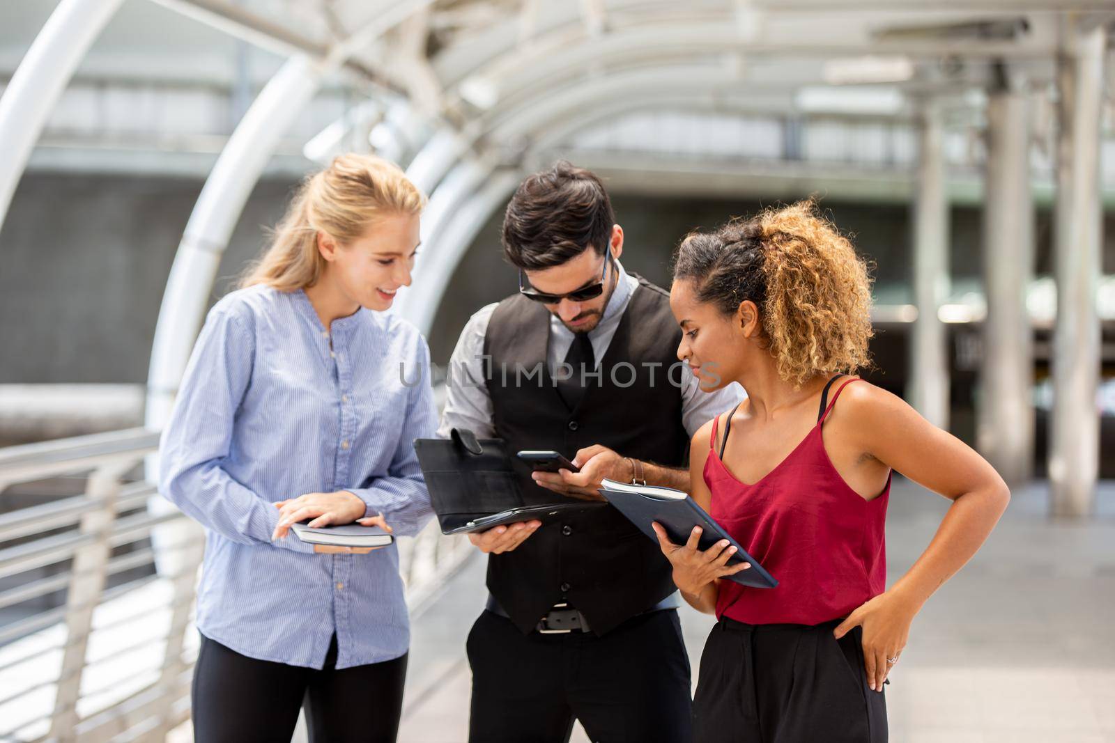 business persons talking or chatting to each other outside the office by chuanchai