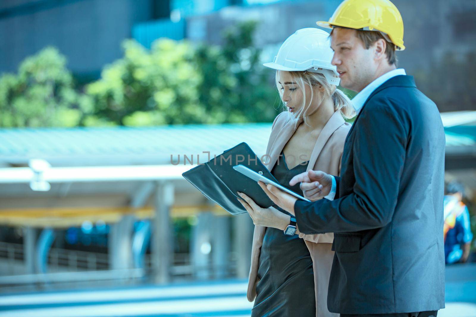 The engineer and business people hand high five against building. The concept of engineering, construction, city life and future. by chuanchai