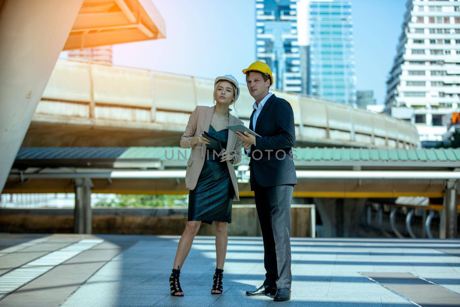 The engineer and business people hand high five against building. The concept of engineering, construction, city life and future.