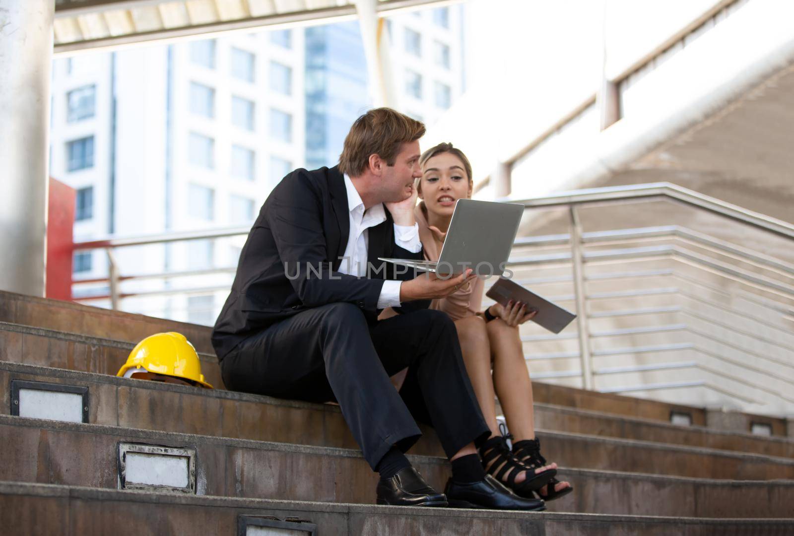 The engineer and business people hand high five against building. The concept of engineering, construction, city life and future.