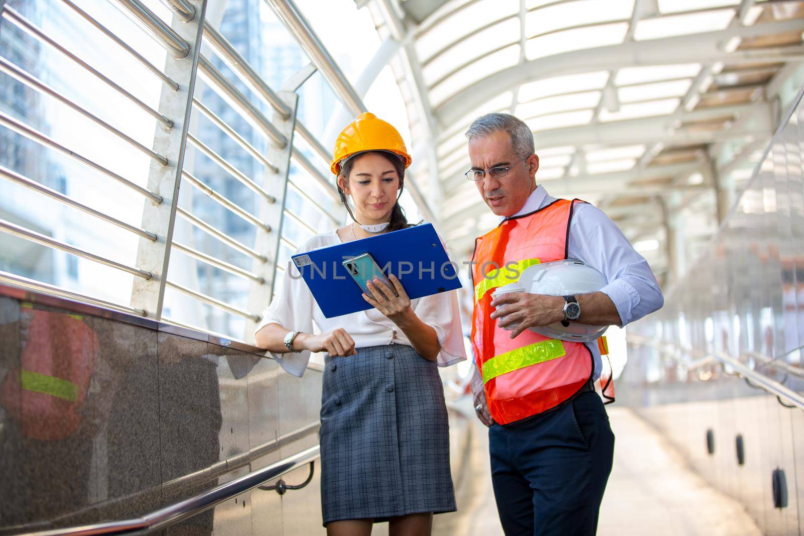 The engineer and business people hand high five against building. The concept of engineering, construction, city life and future. by chuanchai