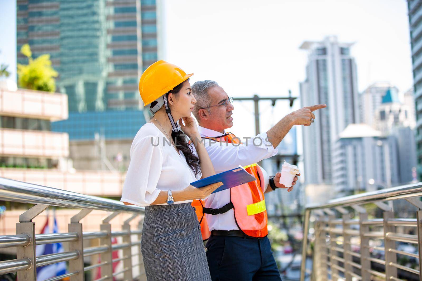 The engineer and business people hand high five against building. The concept of engineering, construction, city life and future.