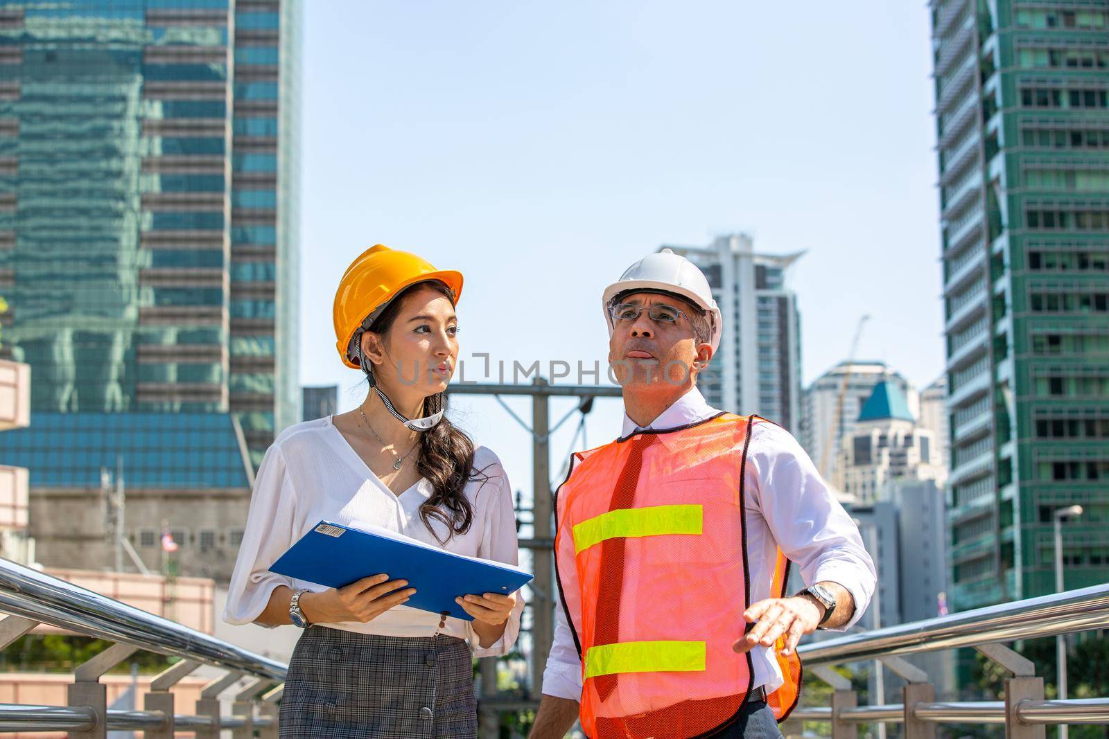 The engineer and business people hand high five against building. The concept of engineering, construction, city life and future. by chuanchai