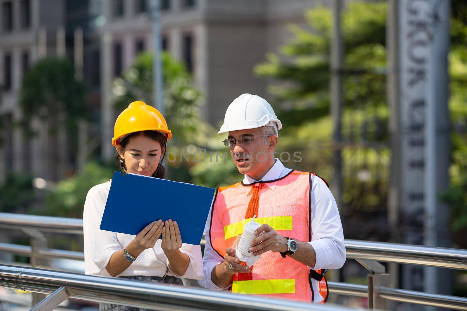 The engineer and business people hand high five against building. The concept of engineering, construction, city life and future. by chuanchai