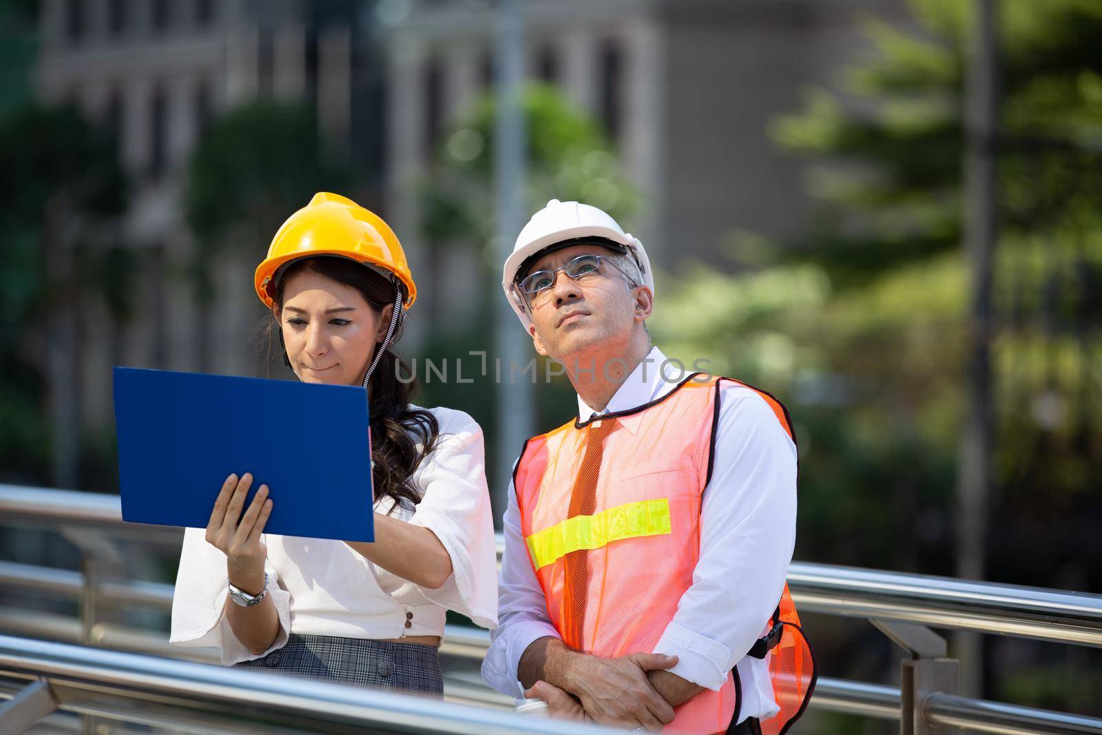 The engineer and business people hand high five against building. The concept of engineering, construction, city life and future.