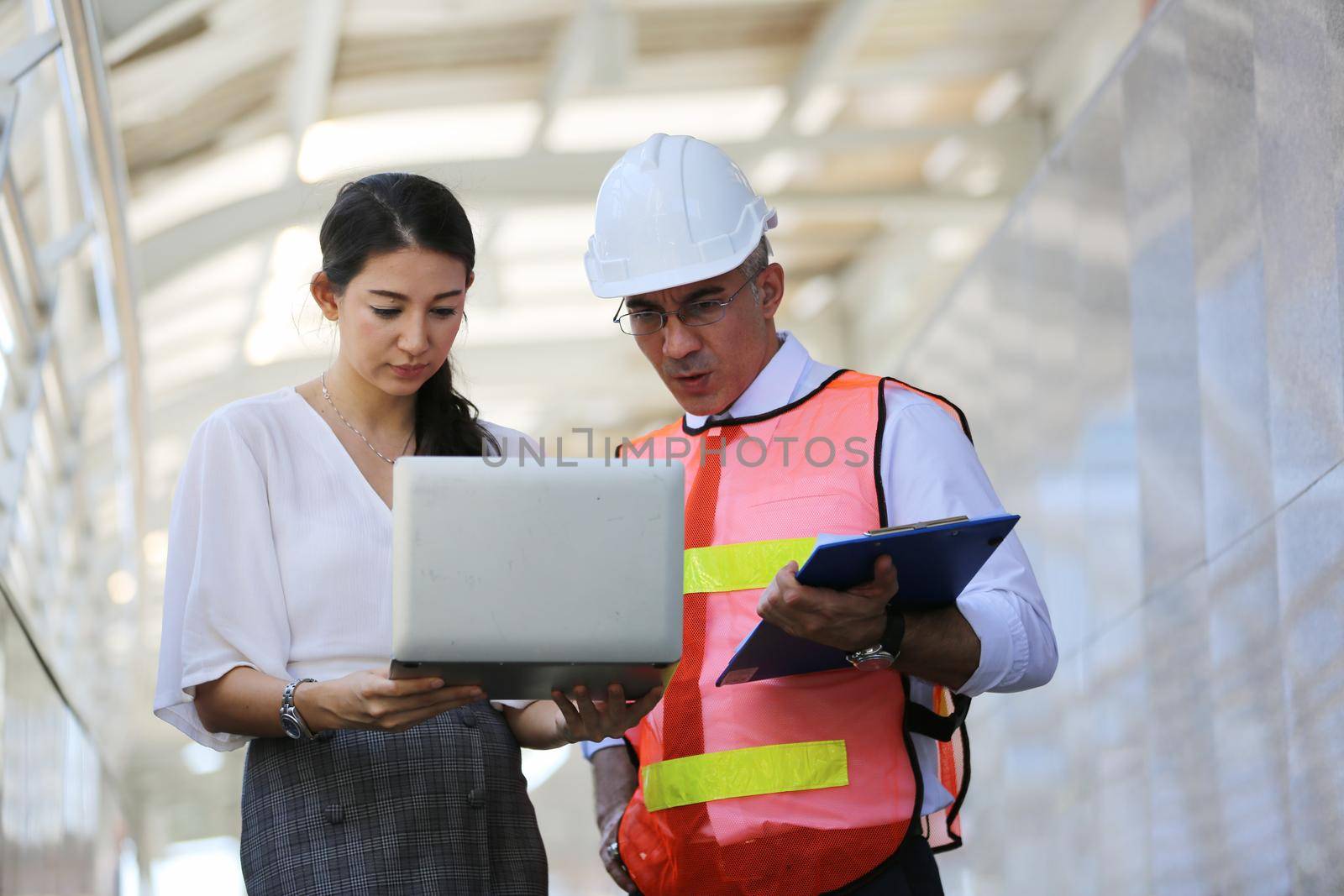 Construction engineers discussion with architects at construction site or building site