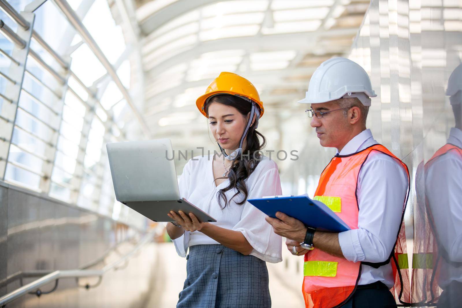 The engineer and business people hand high five against building. The concept of engineering, construction, city life and future.