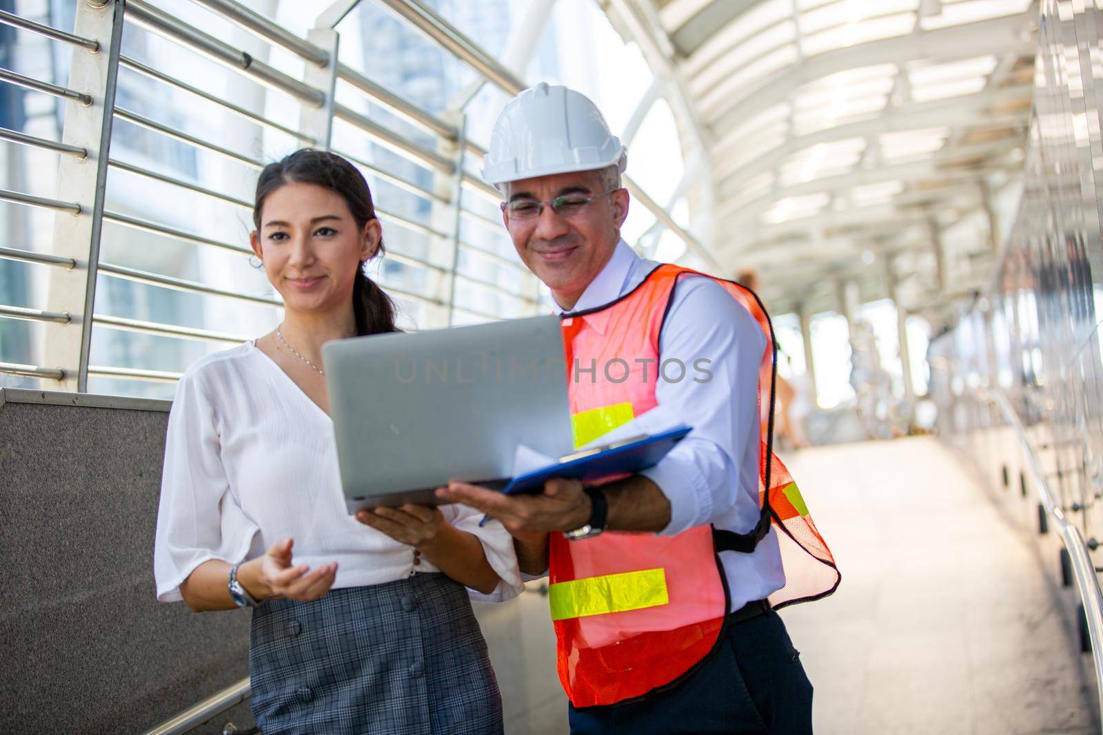 The engineer and business people hand high five against building. The concept of engineering, construction, city life and future.