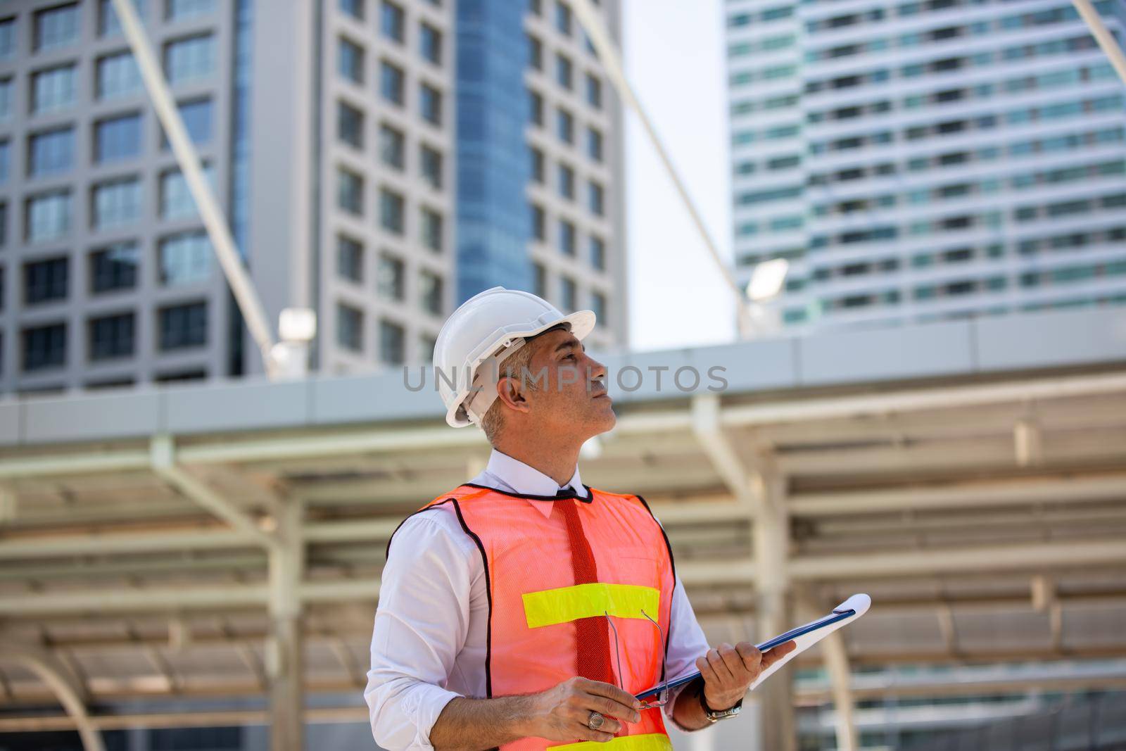 The engineer and business people hand high five against building. The concept of engineering, construction, city life and future.