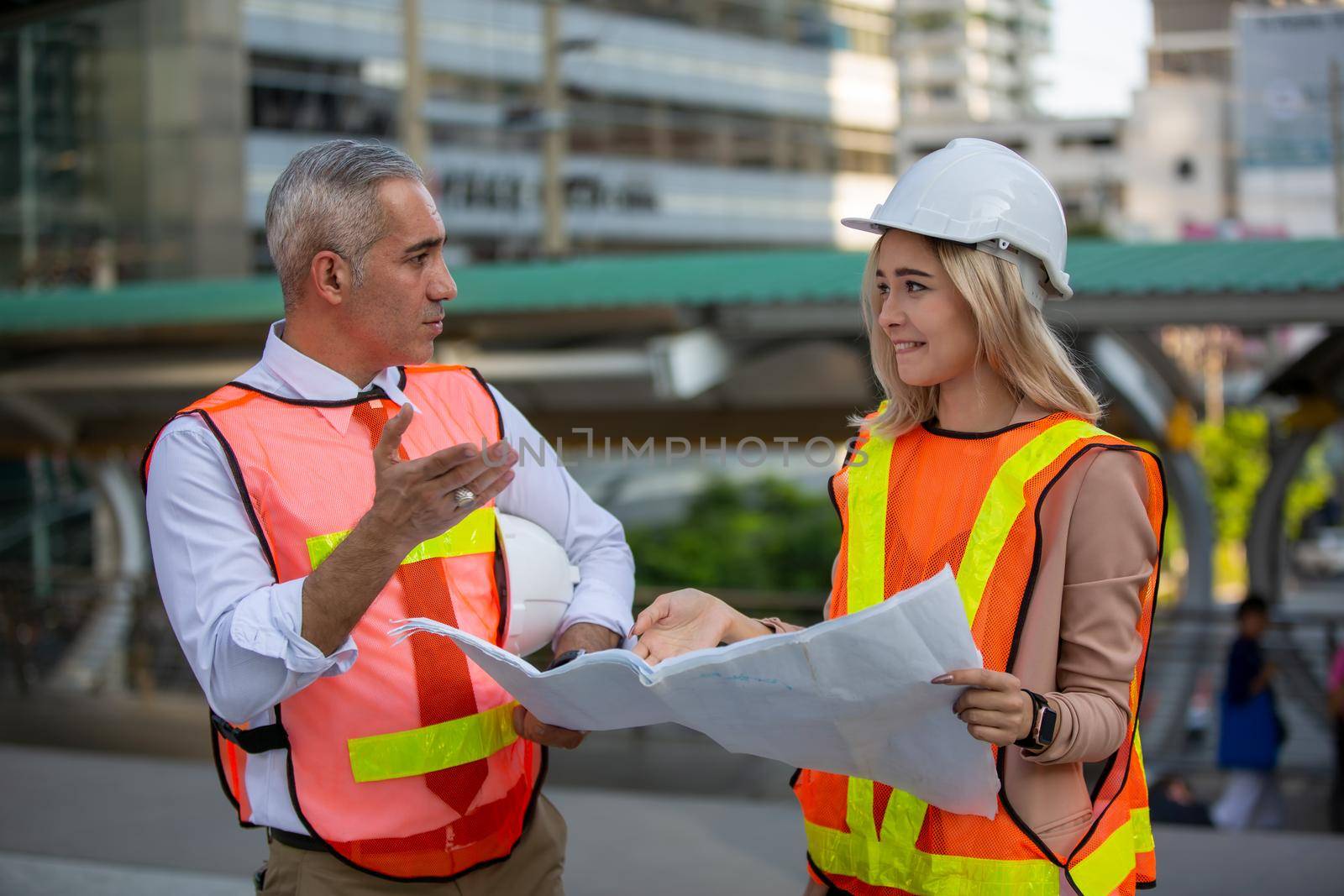 Construction engineers discussion with architects at construction site or building site