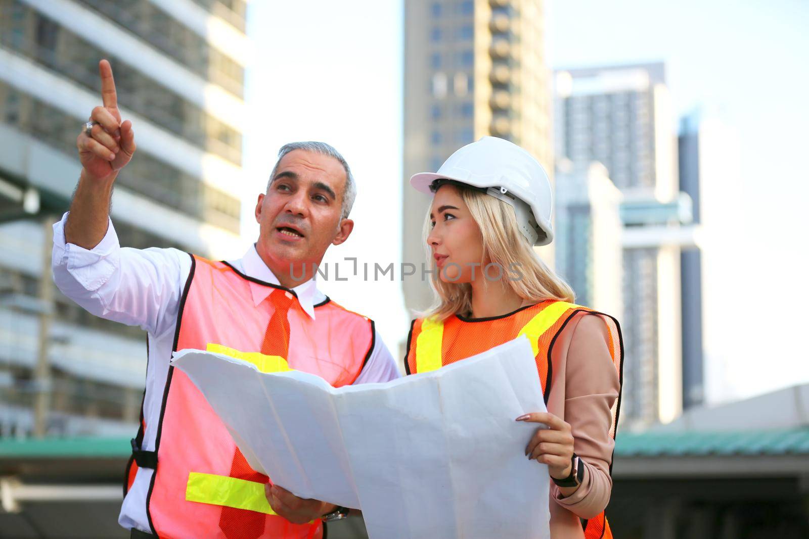 The engineer and business people hand high five against building. The concept of engineering, construction, city life and future. by chuanchai