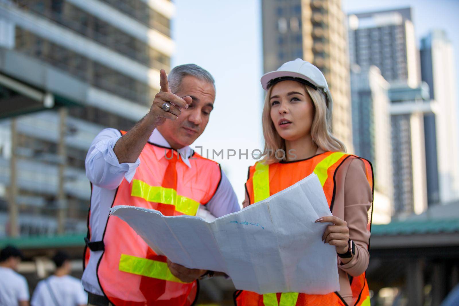 Engineering civil, Construction engineers discussion with architects at construction site or building site of high-rise building with Surveying for making contour plans by chuanchai