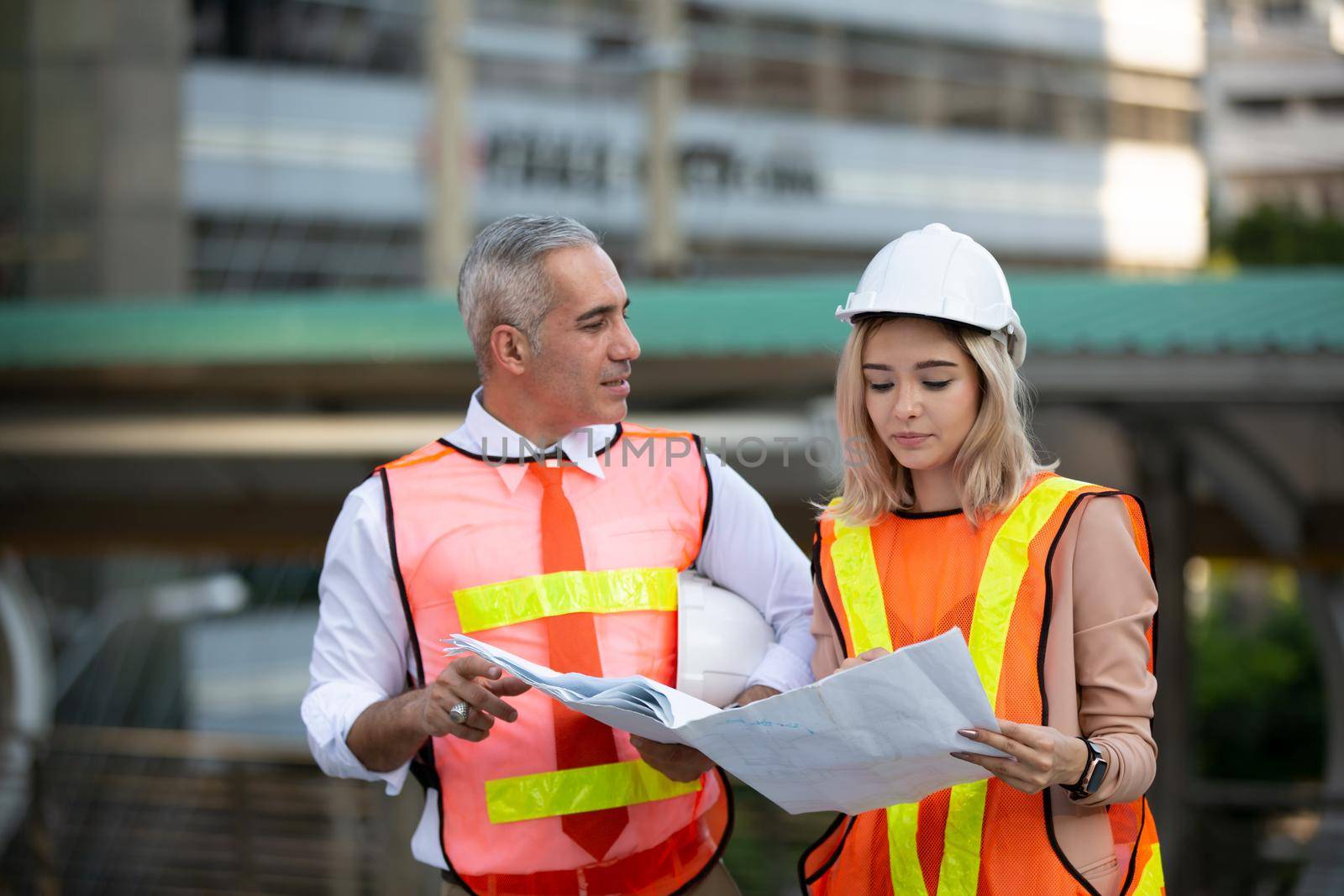 Engineering civil, Construction engineers discussion with architects at construction site or building site of high-rise building with Surveying for making contour plans