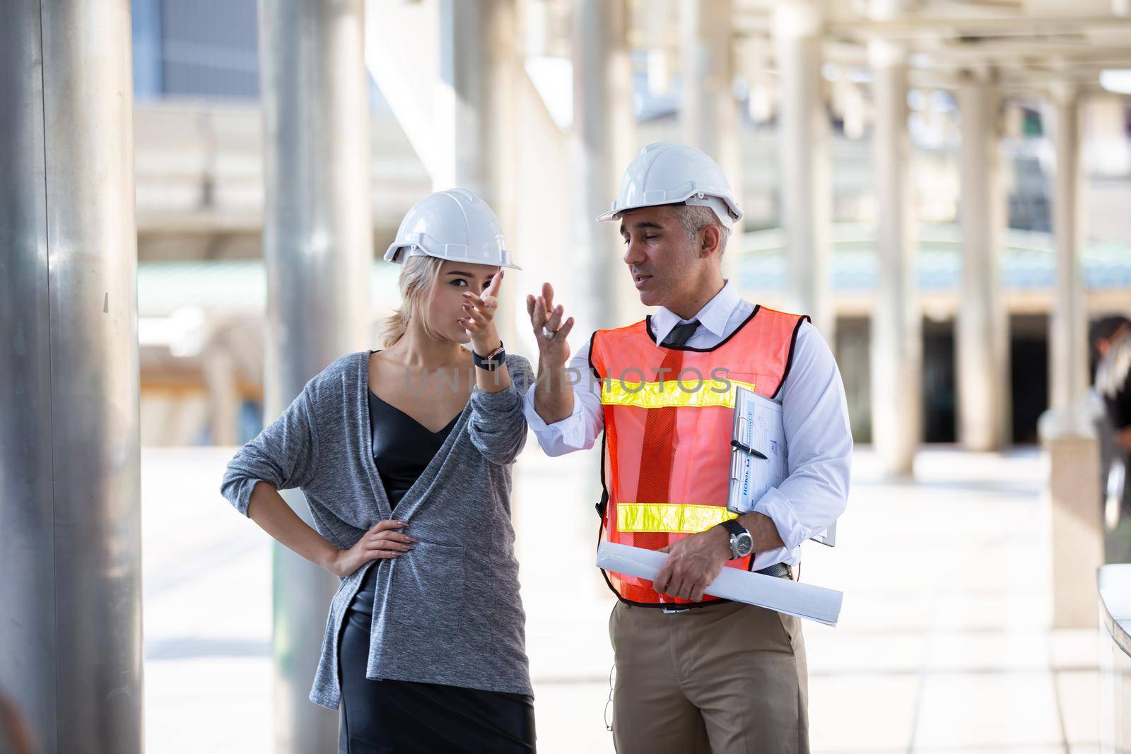 Engineering civil, Construction engineers discussion with architects at construction site or building site of high-rise building with Surveying for making contour plans