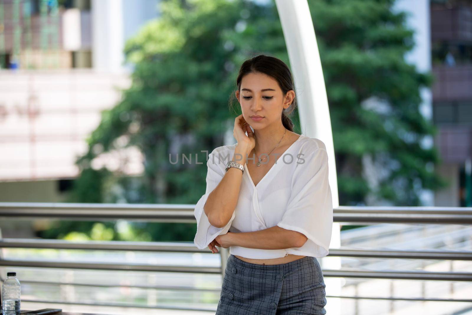 Portrait of young beautiful business woman at outside. Crossed arms by chuanchai