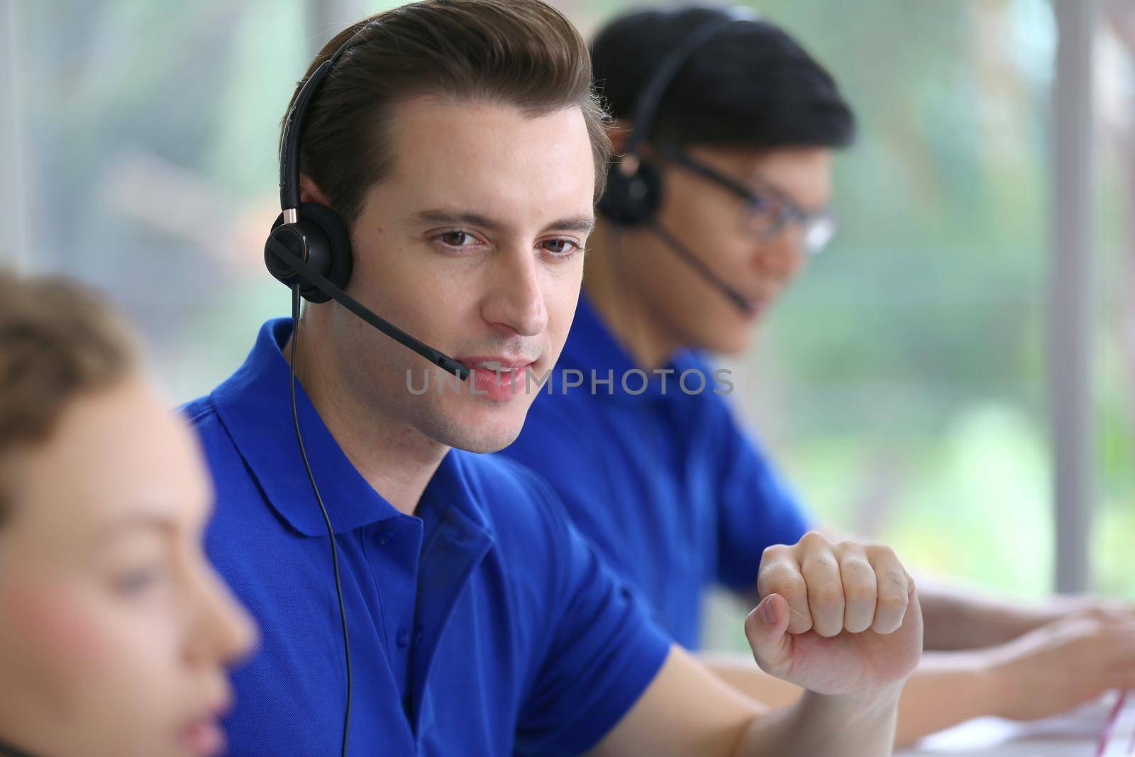 Call center operator in headset while consulting client. Telemarketing or phone sales. Customer service and business concept. by chuanchai