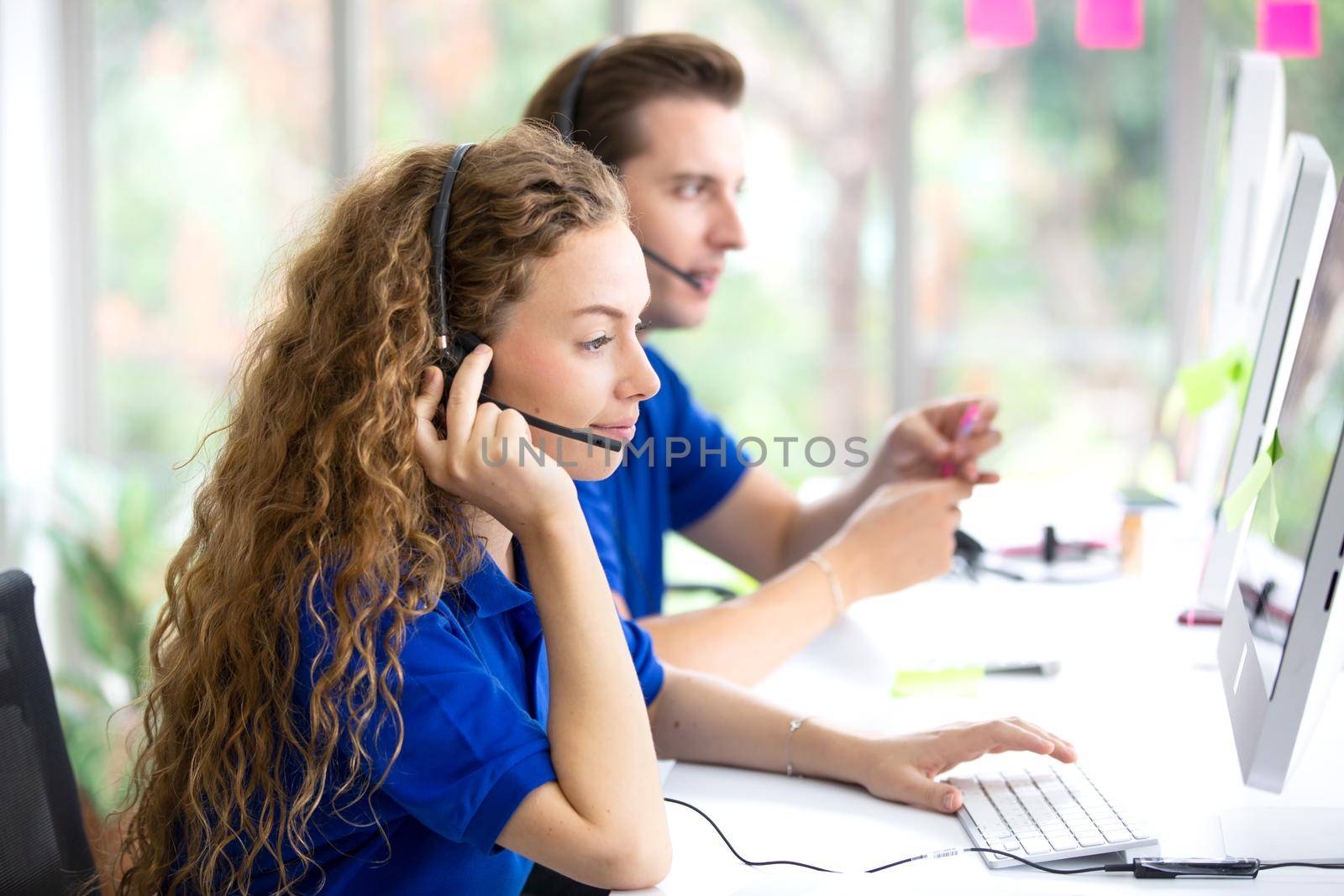 Call center operators.Call center operator in headset while consulting client. Telemarketing or phone sales. Customer service and business concept. by chuanchai