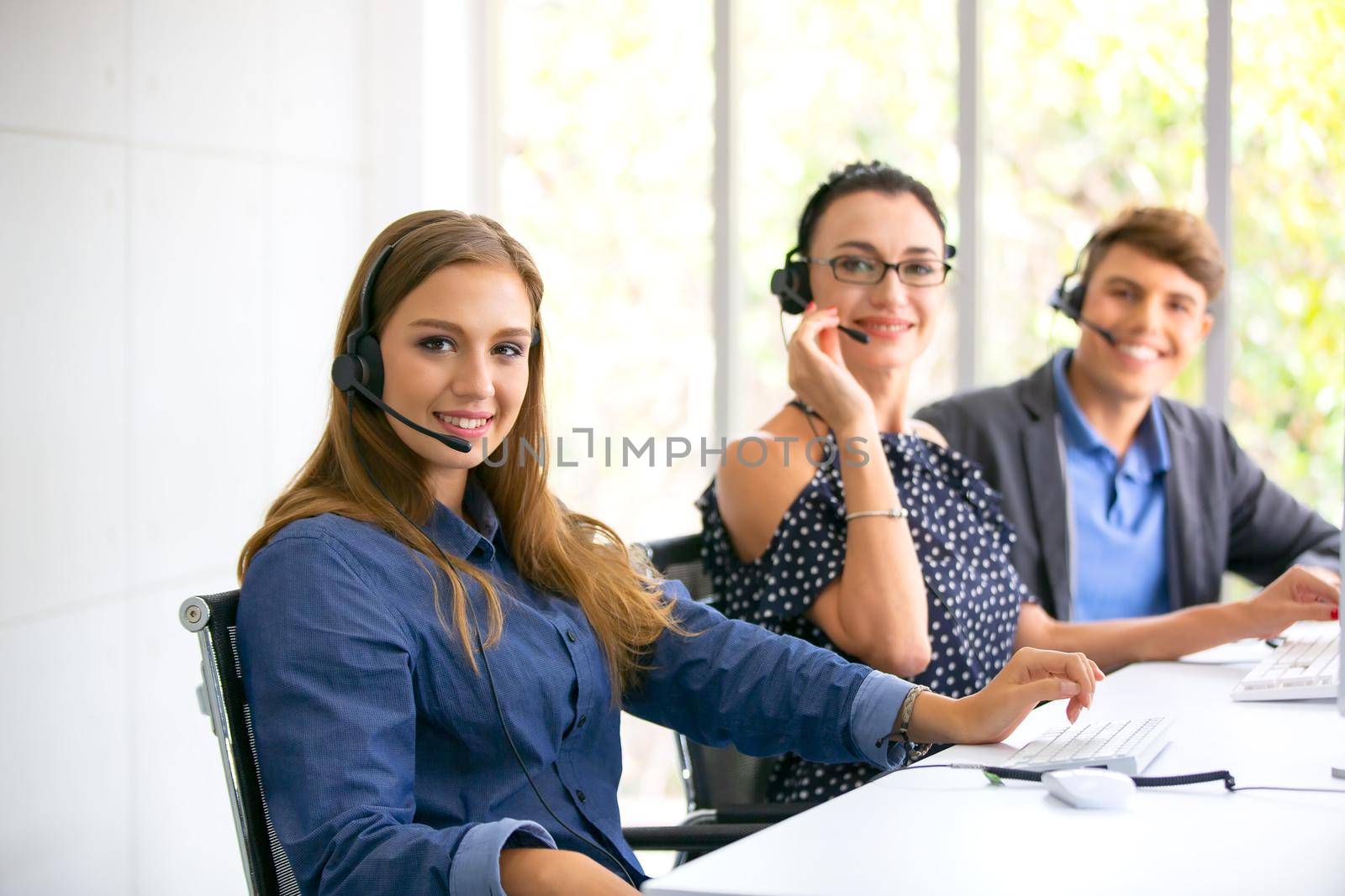 Call center operator in headset while consulting client. Telemarketing or phone sales. Customer service and business concept.