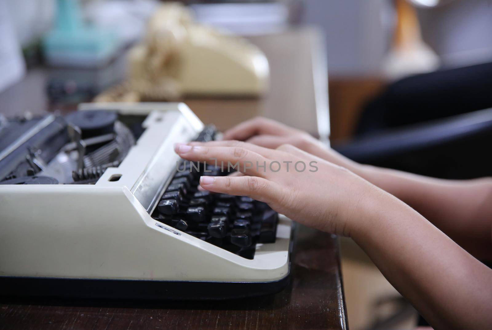 Close-up on women hand typing on type writer. by chuanchai