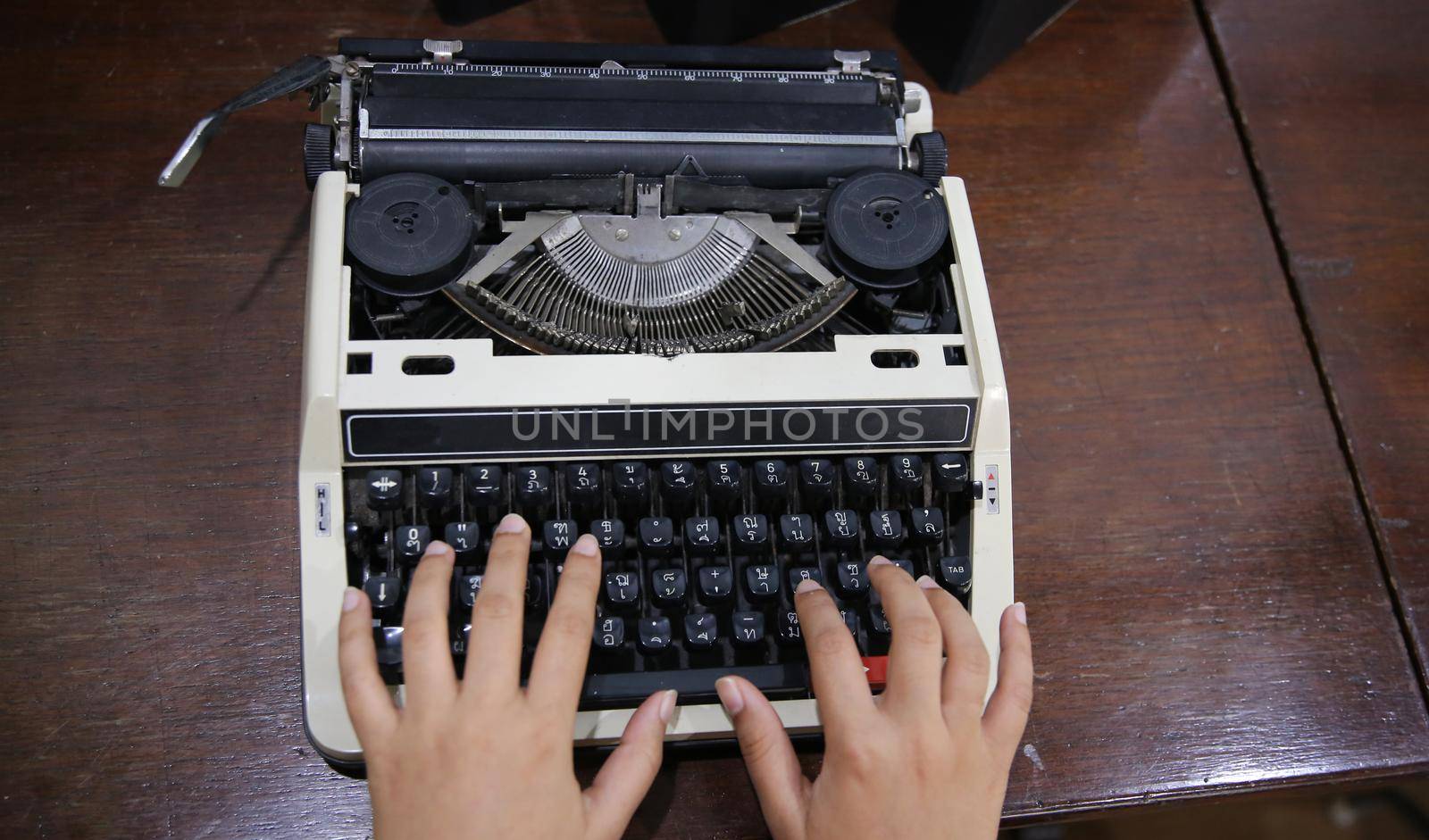 Close-up on women hand typing on type writer.