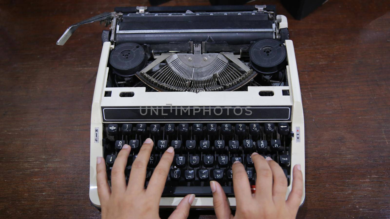 Close-up on women hand typing on type writer. by chuanchai