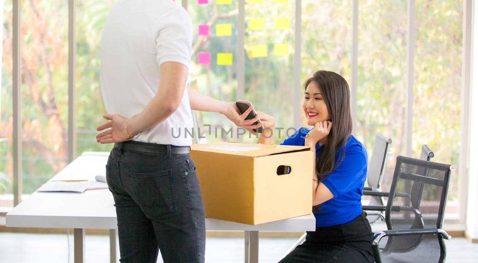 Young man delivered the parcel. Courier with a cardboard box. Parcel Delivery Service. by chuanchai