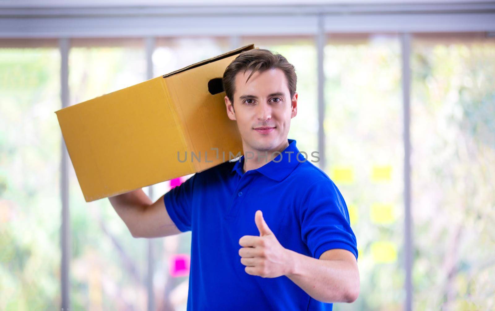 delivery man blue t-shirt holding box in call center office