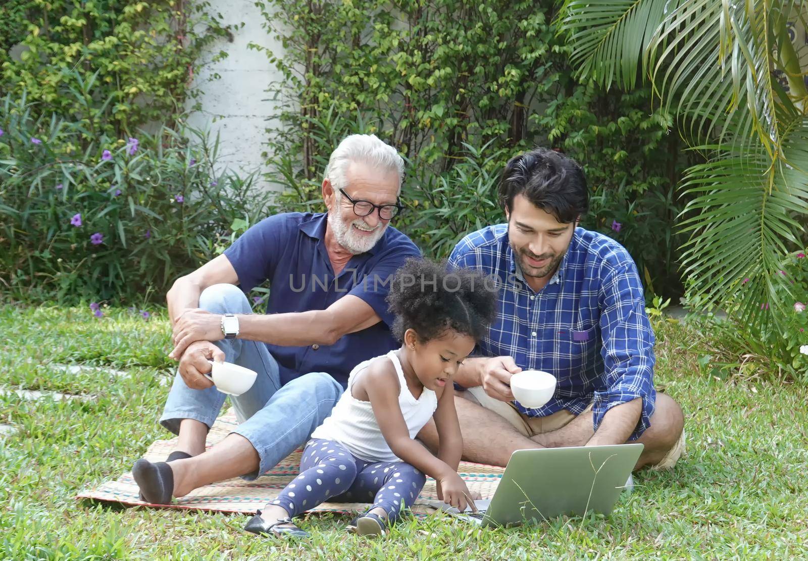 Mix race of family, dad, mom and daughters play together in park