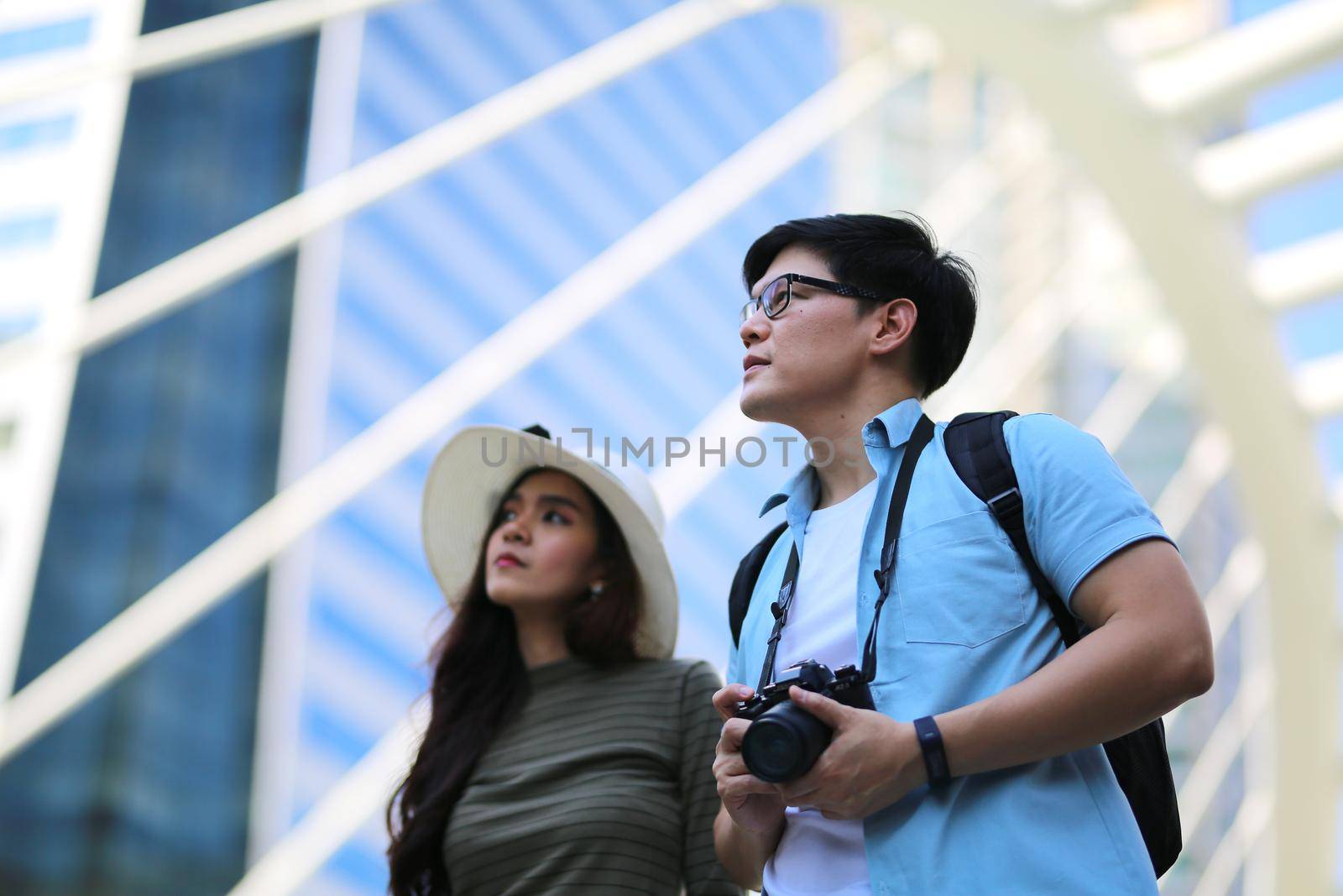 Asian couple enjoy travelling and walking on the street in city.