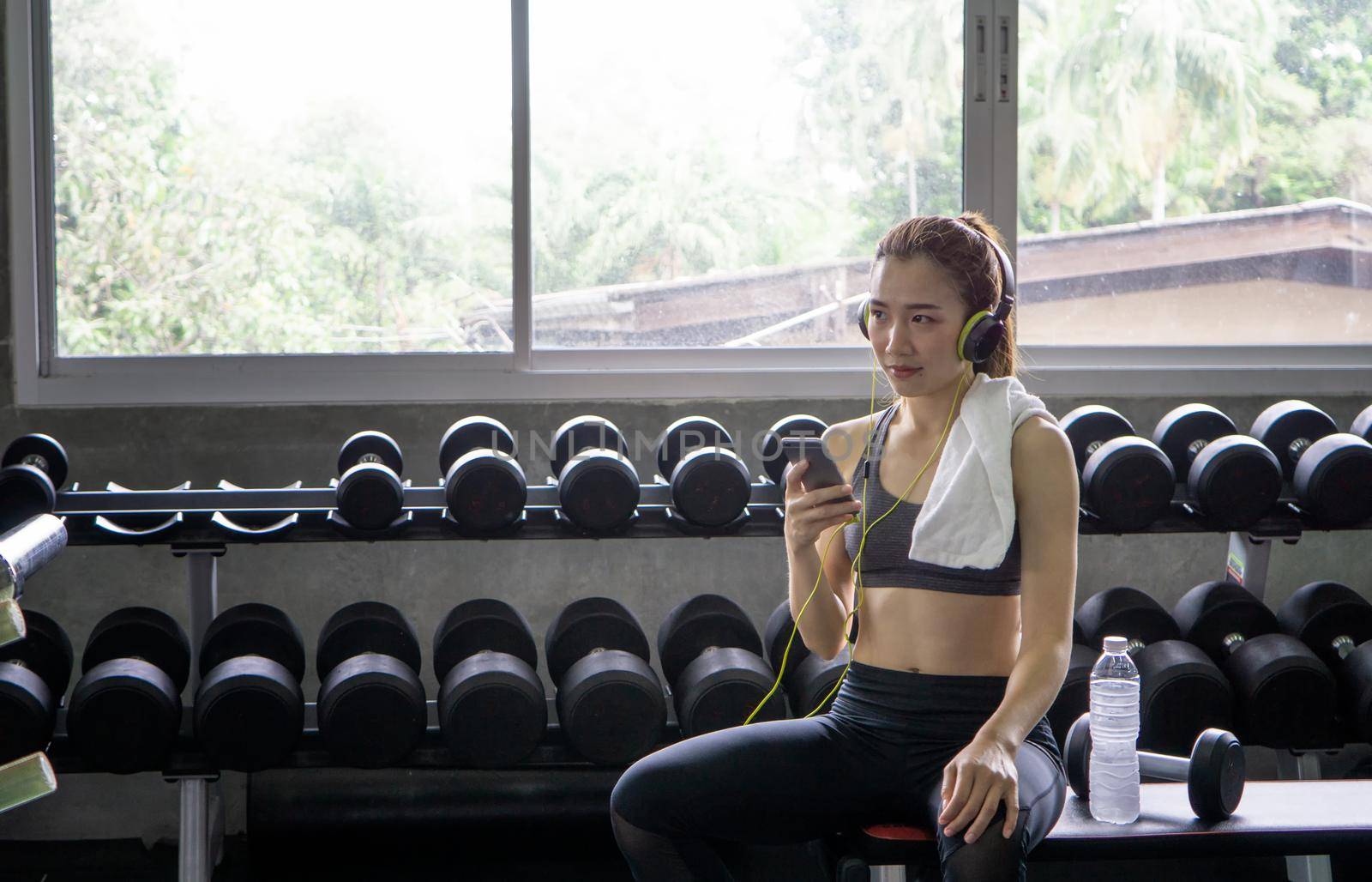 Athletic young people in sportswear doing fitness stretching exercises at fitness gym. Sport and recreation concept. by chuanchai