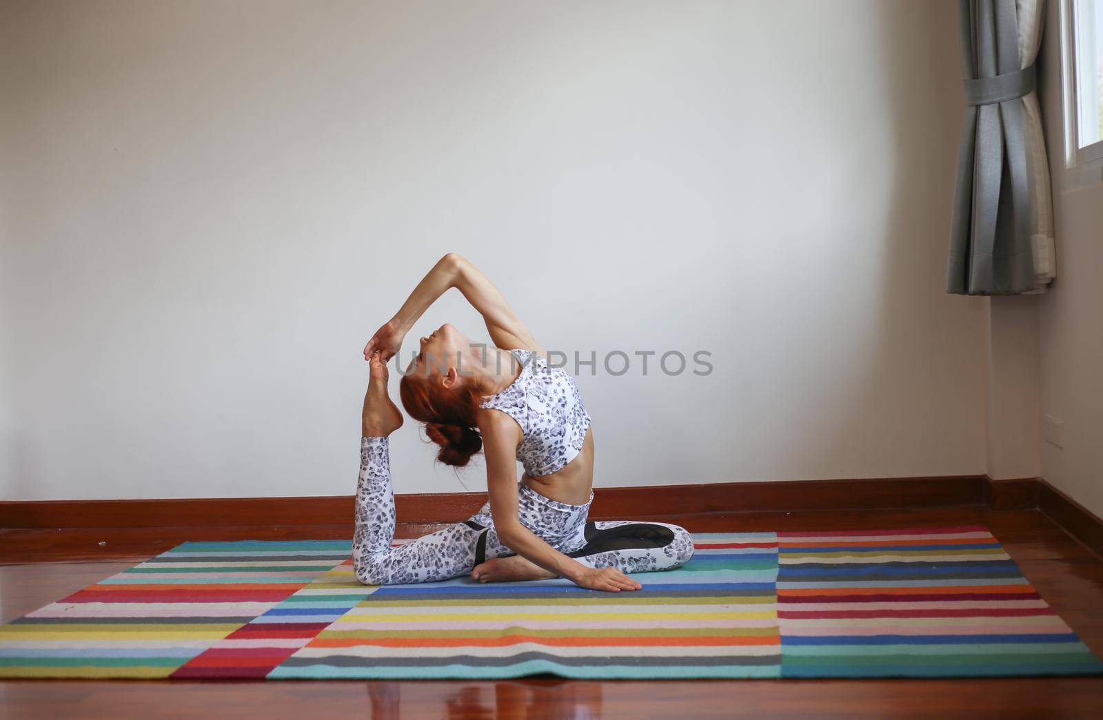 Women practice yoga at home by chuanchai