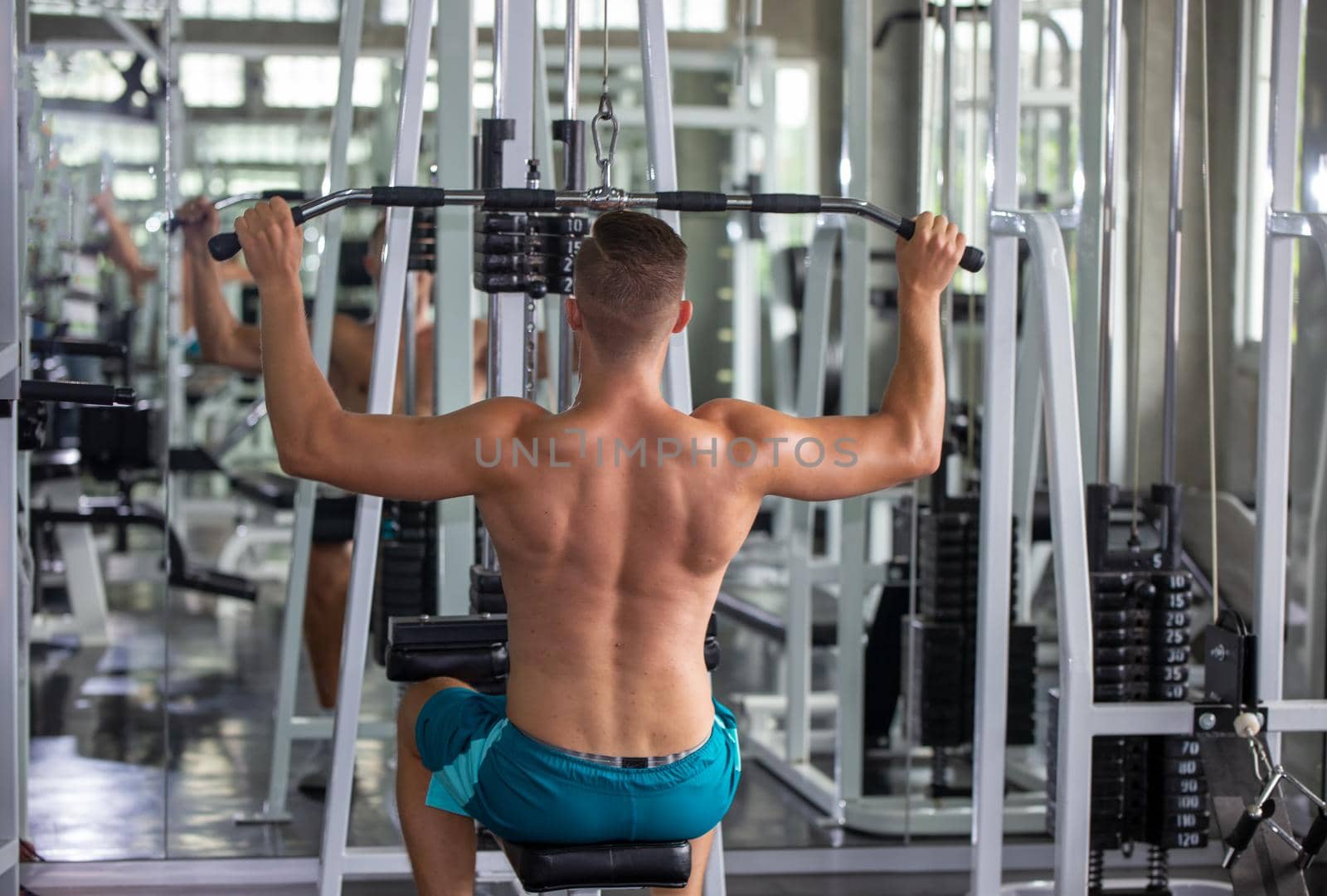 sport, fitness, lifestyle and people concept - group of men flexing muscles with dumbbells in gym by chuanchai