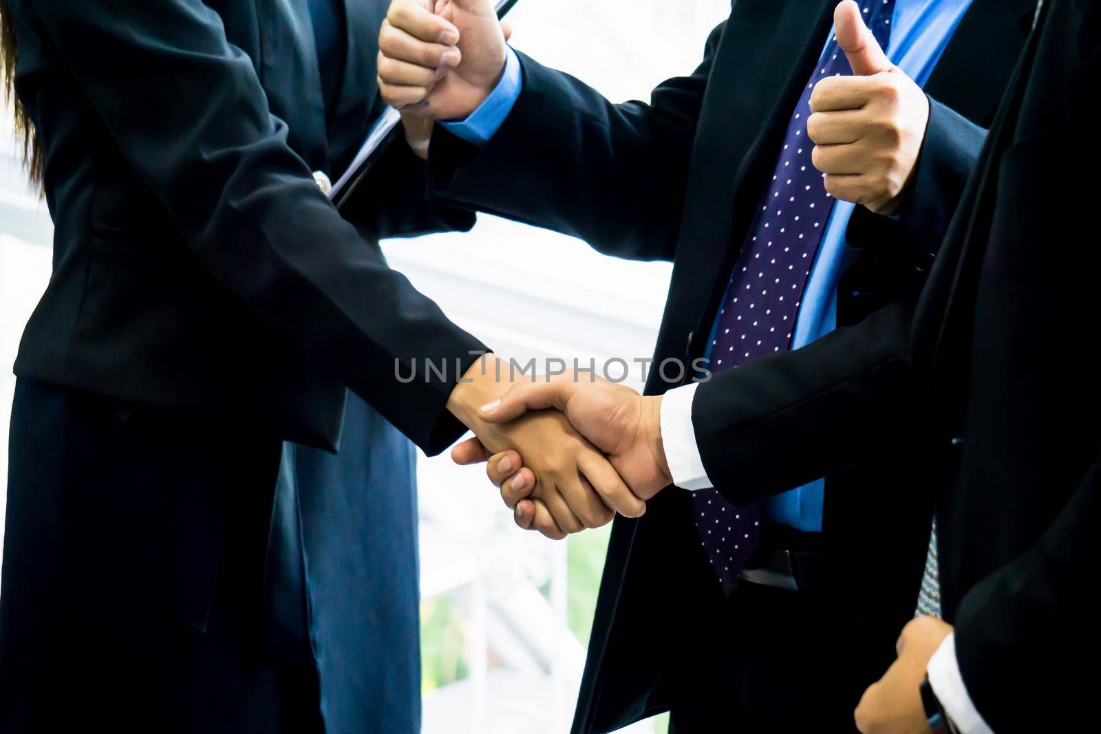 Business people shaking hands after successful negotiations by chuanchai