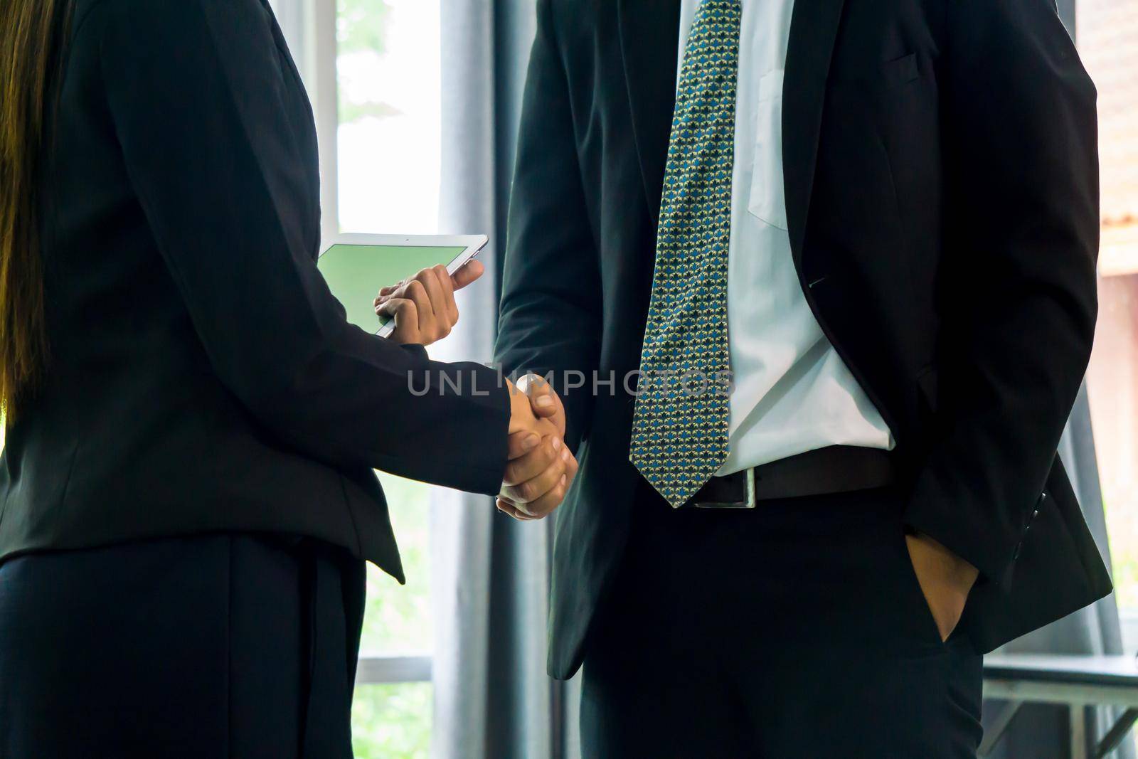 Business people shaking hands, finishing up a papers signing. Meeting, contract and lawyer consulting concept.