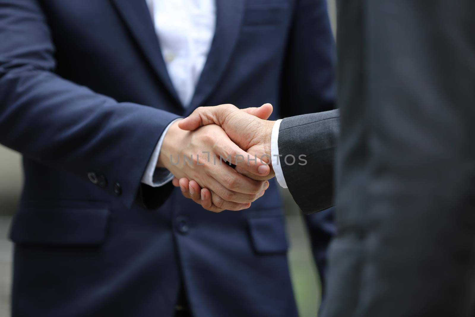 Business people shaking hands, finishing up a papers signing. Meeting, contract and lawyer consulting concept.