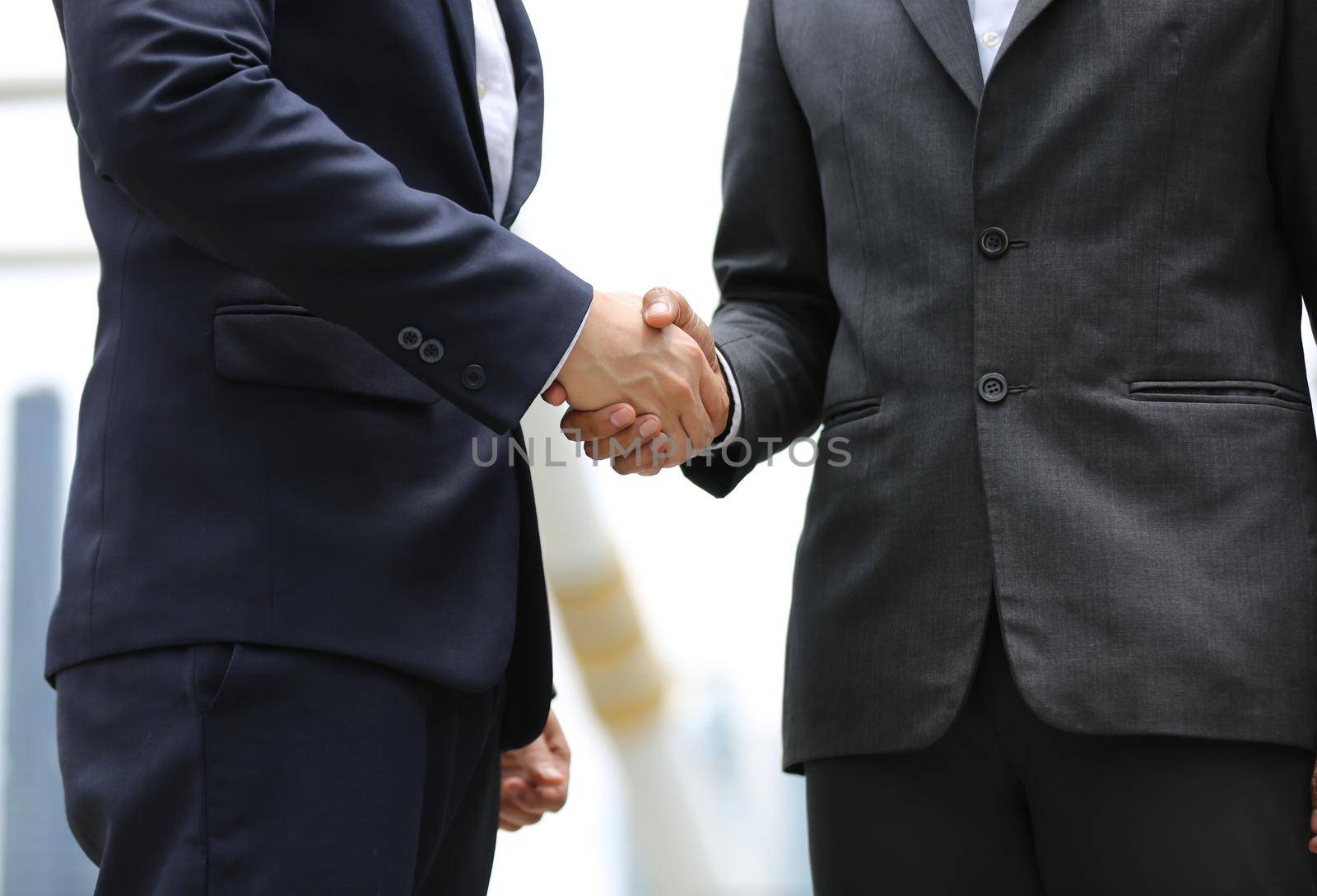 Business people shaking hands, finishing up a papers signing. Meeting, contract and lawyer consulting concept.