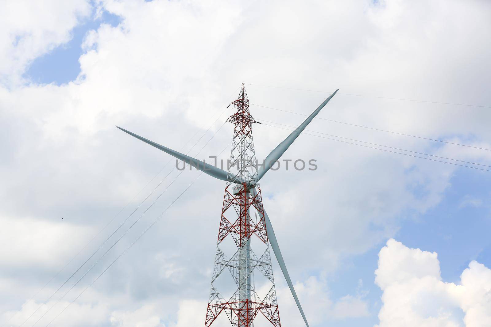 clean energy power concept, wind turbine and cloud sky.