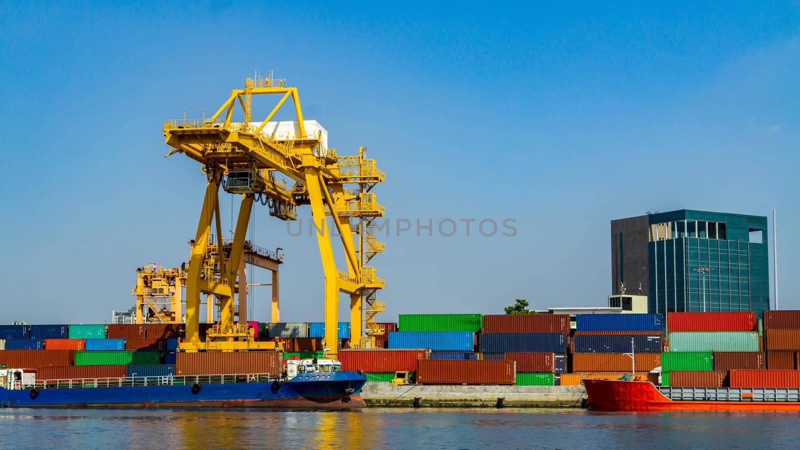 Logistics and transportation of Container Cargo ship and Cargo plane with working crane bridge in shipyard at sunrise, logistic import export and transport industry background